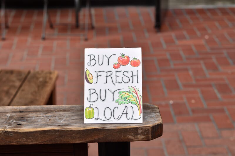 An image of Buy Local sign on a table.